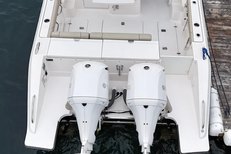  Yacht Photos Pics 2018 Pursuit OS 325 Offshore boat with dual outboard engines, docked at a marina.