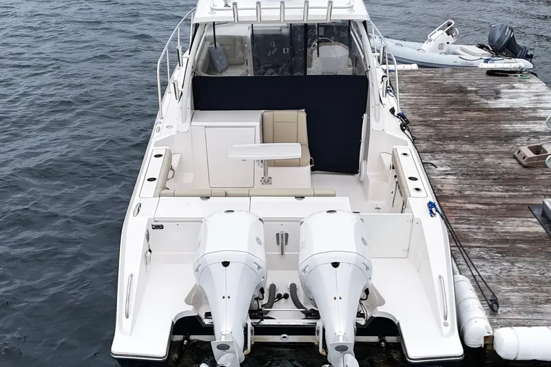  Yacht Photos Pics 2018 Pursuit OS 325 Offshore boat docked, featuring dual outboard engines.