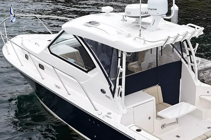 Yacht Photos Pics 2018 Pursuit OS 325 Offshore boat docked, featuring sleek design and modern equipment.
