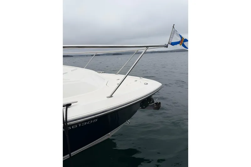  Yacht Photos Pics 2018 Pursuit OS 325 Offshore boat on calm water with a flag.