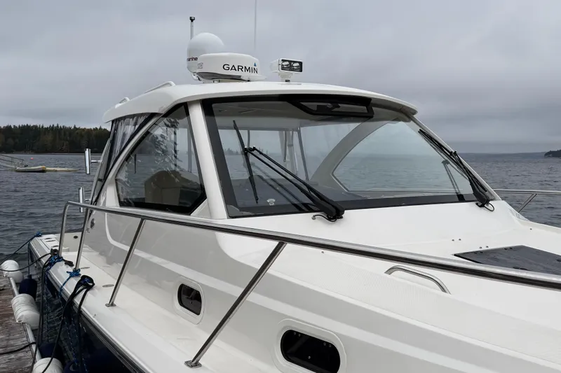  Yacht Photos Pics 2018 Pursuit OS 325 Offshore boat docked on a cloudy day, featuring Garmin equipment.