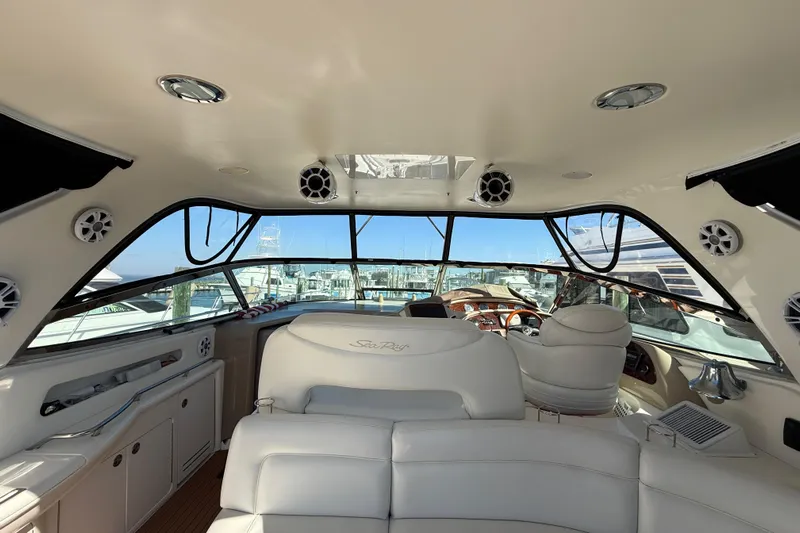  Yacht Photos Pics Interior view of 2003 Sea Ray 460 Sundancer yacht with luxurious seating and helm.