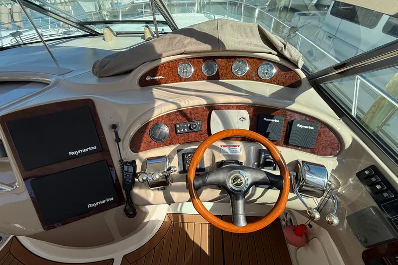  Yacht Photos Pics Helm of 2003 Sea Ray 460 Sundancer with Raymarine electronics and wooden steering wheel.