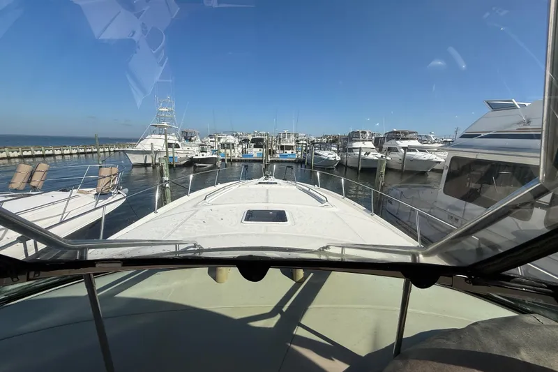  Yacht Photos Pics View from 2003 Sea Ray 460 Sundancer yacht, docked at a marina under clear blue skies.