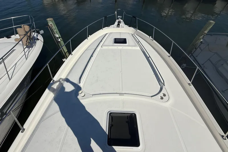  Yacht Photos Pics 2003 Sea Ray 460 Sundancer yacht deck with shadow, docked at marina.