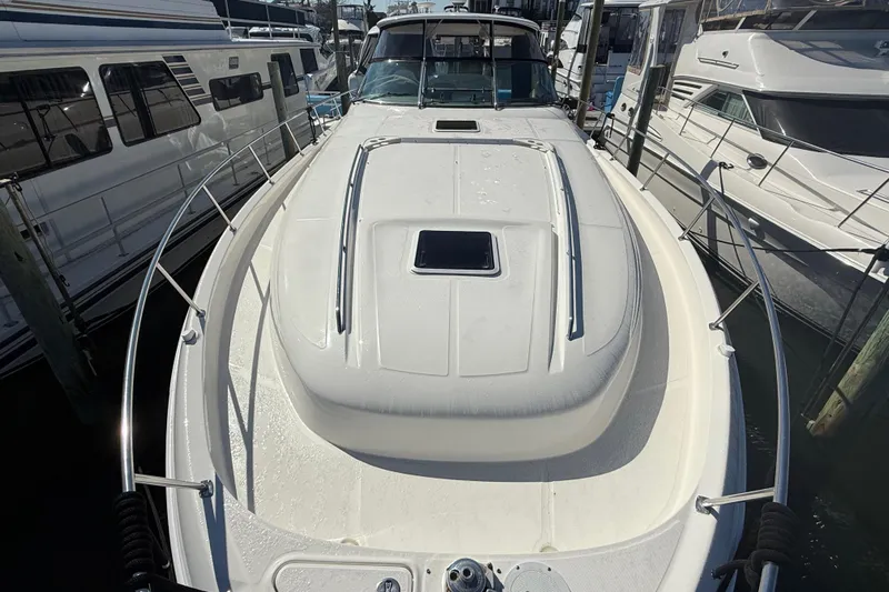  Yacht Photos Pics 2003 Sea Ray 460 Sundancer yacht docked among other boats at a marina.