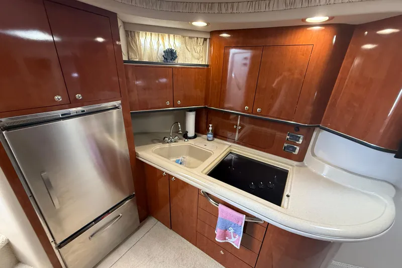  Yacht Photos Pics Luxurious 2003 Sea Ray 460 Sundancer yacht kitchen with wood cabinetry and modern appliances.