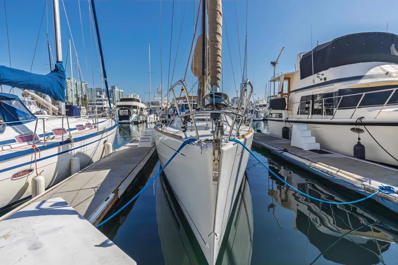 Sabbatical Yacht Photos Pics 2005 Beneteau First 44.7 sailboat docked in a marina, surrounded by other boats.