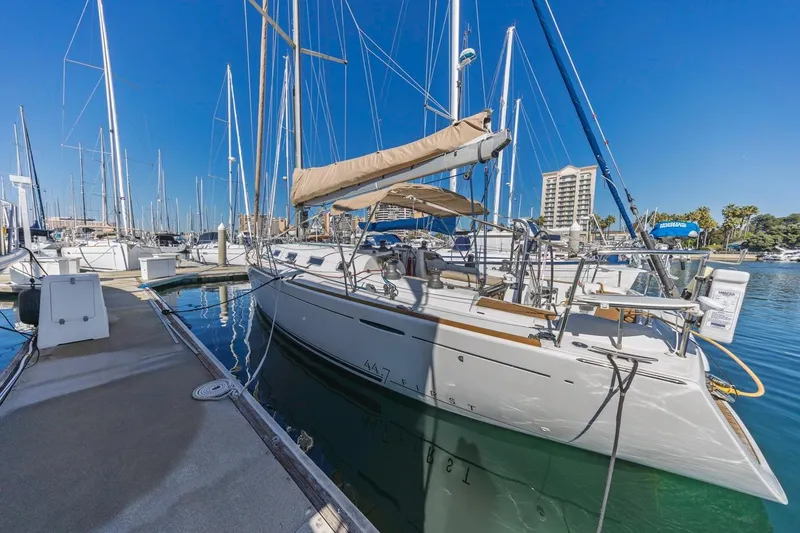 Sabbatical Yacht Photos Pics 2005 Beneteau First 44.7 sailboat docked at marina under clear blue sky.