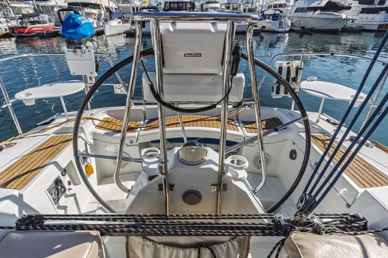 Sabbatical Yacht Photos Pics Cockpit of 2005 Beneteau First 44.7 sailboat in marina, featuring steering wheel and teak decking.