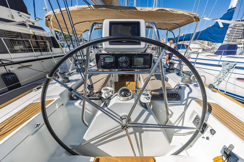 Sabbatical Yacht Photos Pics Cockpit of 2005 Beneteau First 44.7 sailboat with navigation equipment and steering wheel.