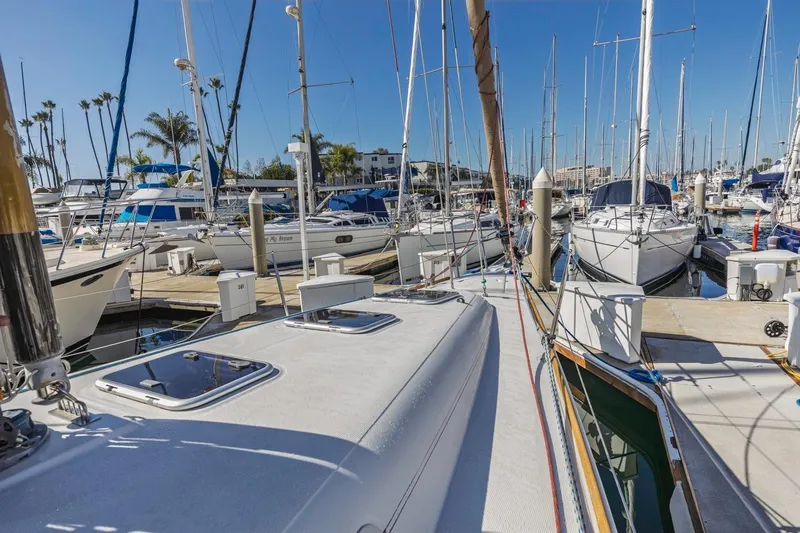 Sabbatical Yacht Photos Pics 2005 Beneteau First 44.7 sailboat docked in a sunny marina with other vessels.