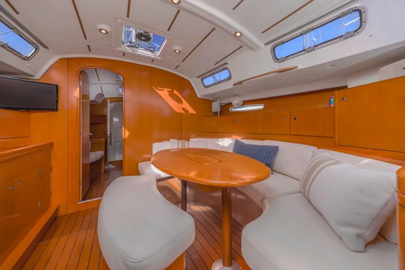 Sabbatical Yacht Photos Pics Luxurious interior of 2005 Beneteau First 44.7 yacht with elegant wood finish and cozy seating.