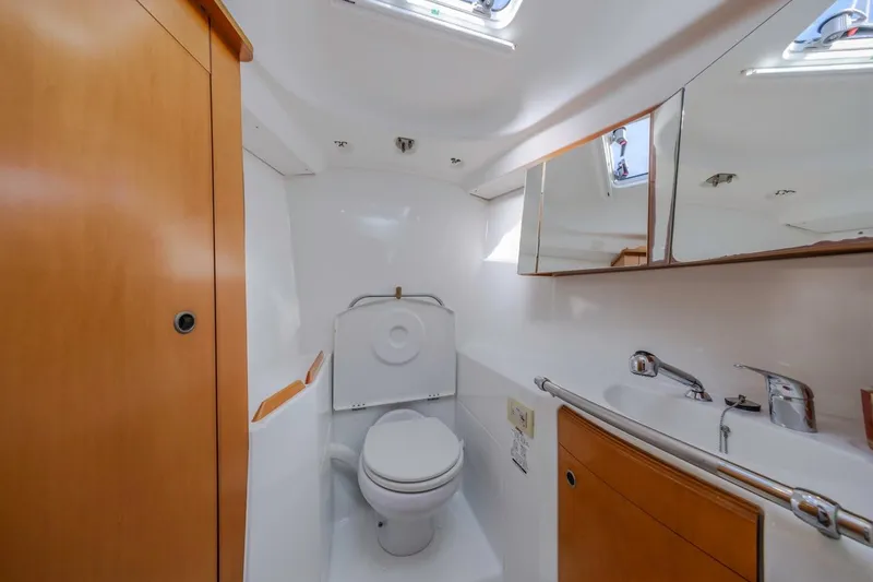 Sabbatical Yacht Photos Pics Luxurious bathroom interior of 2005 Beneteau First 44.7 yacht, featuring modern fixtures and wood accents.