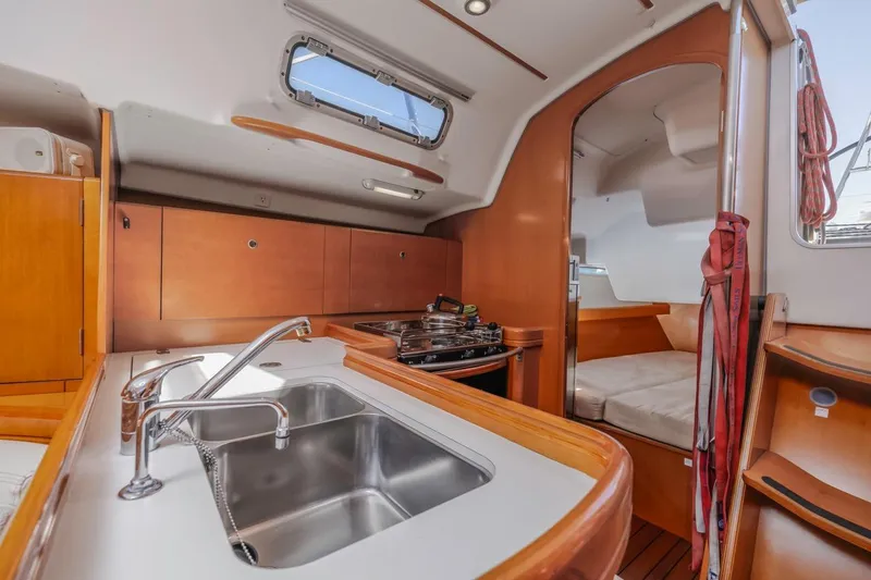 Sabbatical Yacht Photos Pics Interior of 2005 Beneteau First 44.7 yacht with kitchen and seating area.