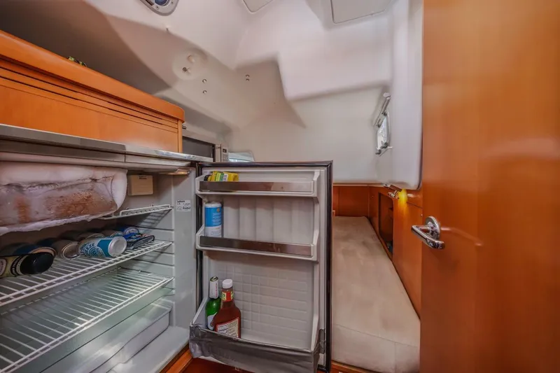 Sabbatical Yacht Photos Pics Interior of 2005 Beneteau First 44.7 yacht with open fridge and cozy cabin.