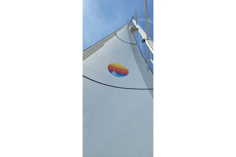  Yacht Photos Pics Sail of 2005 Catalina Morgan 440 yacht with colorful logo against blue sky.