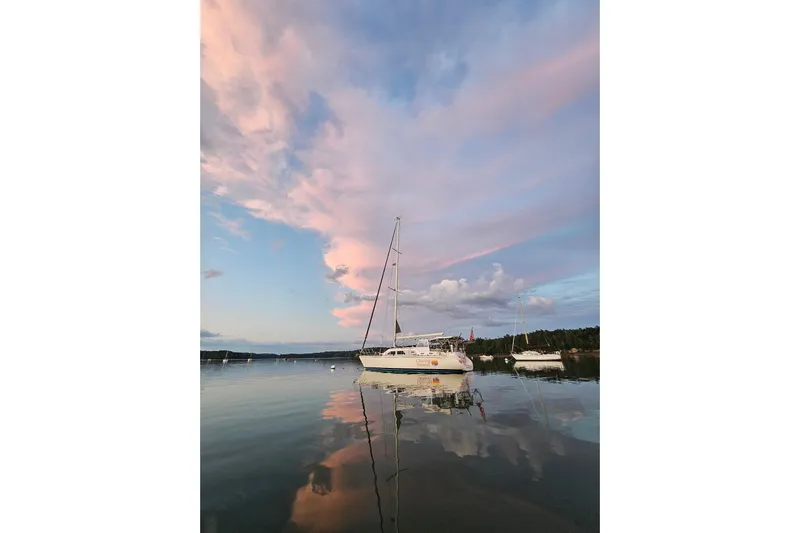  Yacht Photos Pics Sailboat Catalina Morgan 440, 2005, on calm water under pink sunset sky.