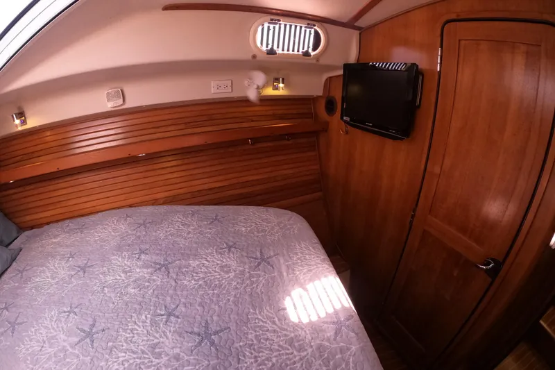  Yacht Photos Pics Cozy cabin interior of 2005 Catalina Morgan 440 yacht with wood paneling and TV.