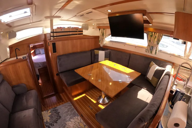  Yacht Photos Pics Luxurious interior of 2005 Catalina Morgan 440 yacht with cozy seating and elegant wood finishes.