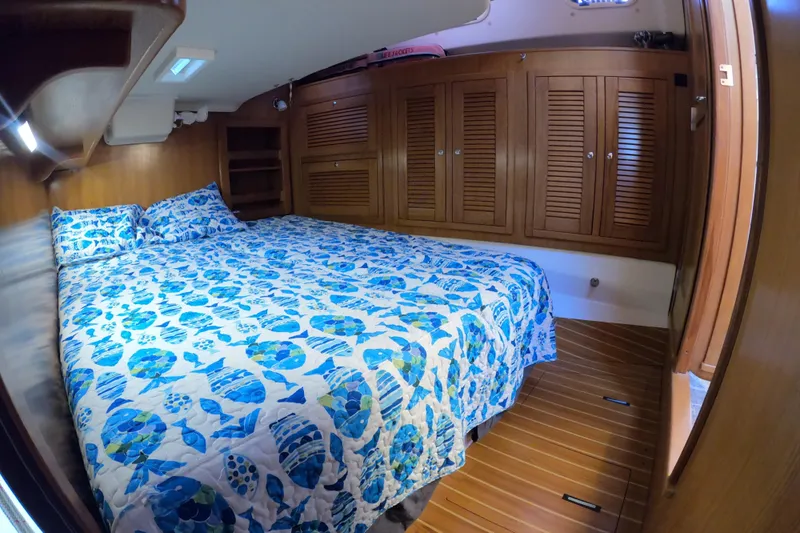  Yacht Photos Pics Cozy cabin interior of 2005 Catalina Morgan 440 with blue patterned bedding.
