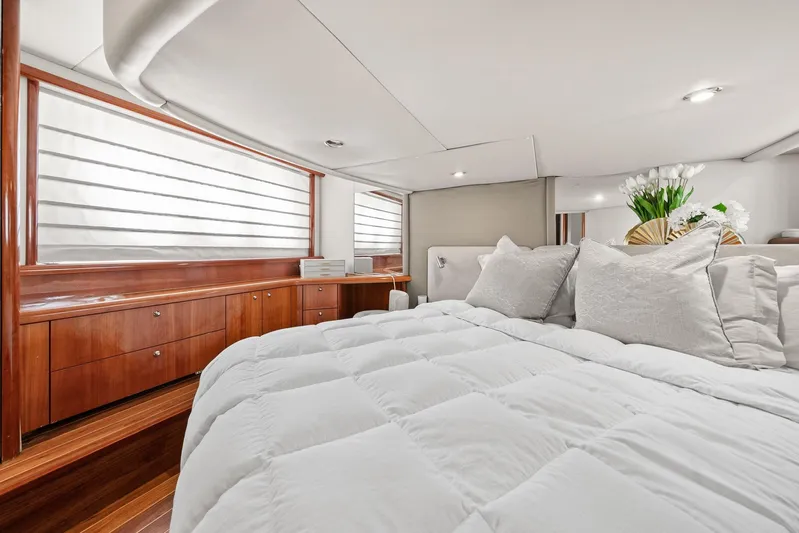  Yacht Photos Pics Luxurious bedroom interior of 2006 Sunseeker Manhattan 50 yacht with elegant wood finishes.