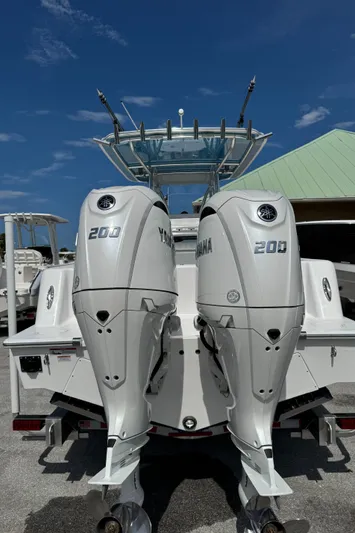  Yacht Photos Pics 2024 Contender 28 Tournament boat with dual Yamaha 200 engines, docked under clear skies.