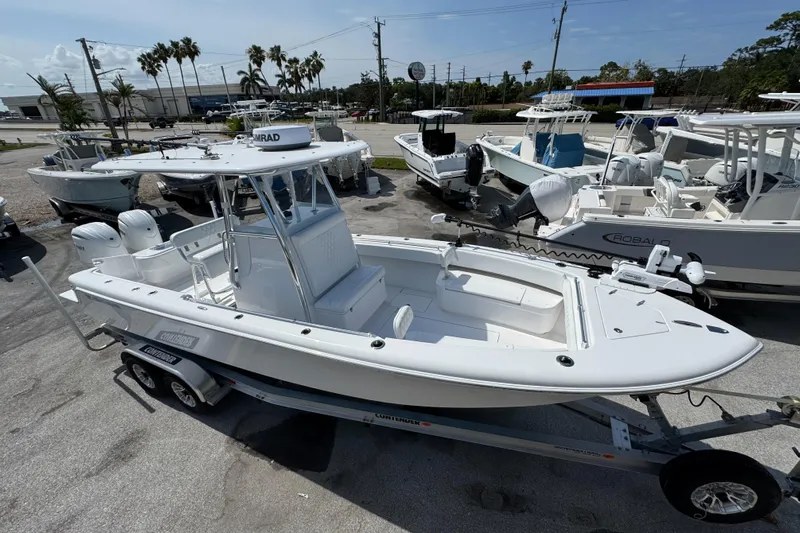  Yacht Photos Pics 2024 Contender 28 Tournament boat on trailer, parked in a marina with other boats.