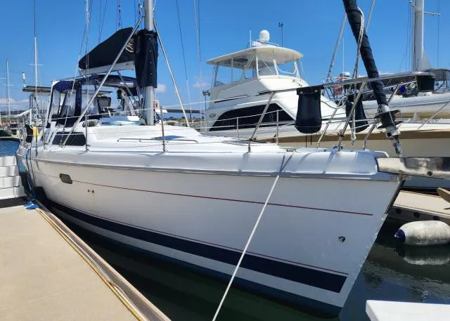 Plan B Yacht Photos Pics Sailboat docked at marina, 1998 Hunter 450 Passage, clear blue sky.