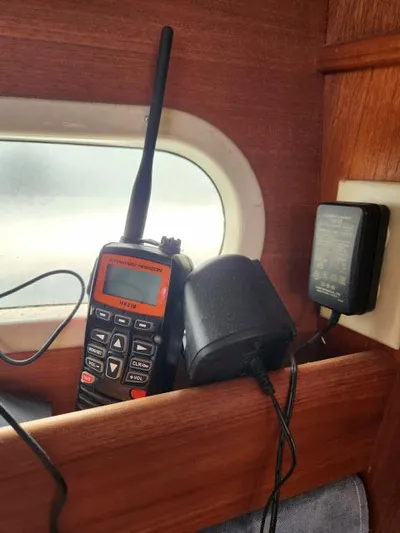 Plan B Yacht Photos Pics Marine radio and charger on a 1998 Hunter 450 Passage sailboat shelf.