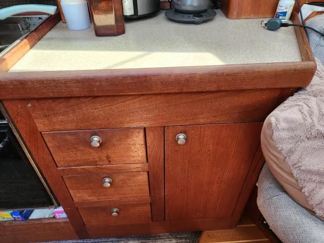 Plan B Yacht Photos Pics Wooden cabinet with drawers in a 1998 Hunter 450 Passage yacht interior.