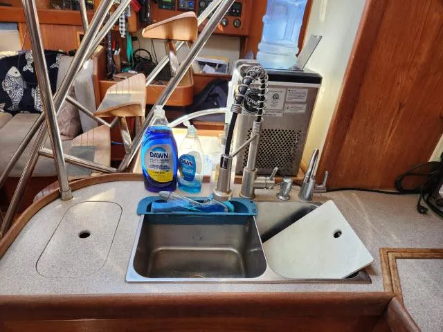 Plan B Yacht Photos Pics Kitchen sink area on a 1998 Hunter 450 Passage yacht with cleaning supplies.
