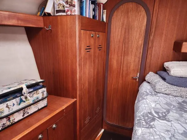 Plan B Yacht Photos Pics Cozy cabin interior of 1998 Hunter 450 Passage sailboat with wooden furnishings and storage.