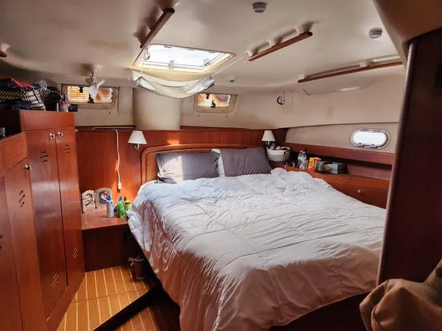 Plan B Yacht Photos Pics Cozy cabin interior of 1998 Hunter 450 Passage yacht with bed and wooden furnishings.
