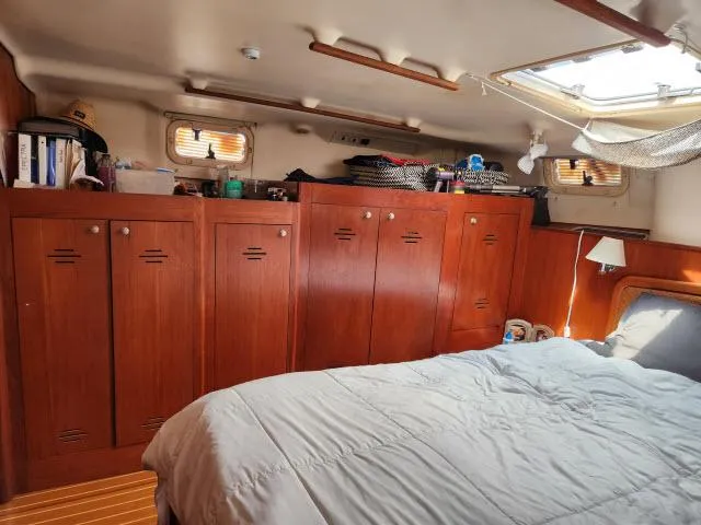 Plan B Yacht Photos Pics Interior of 1998 Hunter 450 Passage yacht with wooden cabinets and cozy bedding.