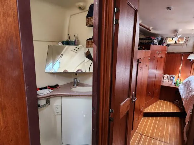 Plan B Yacht Photos Pics Interior of 1998 Hunter 450 Passage yacht with wooden cabinetry and compact bathroom.