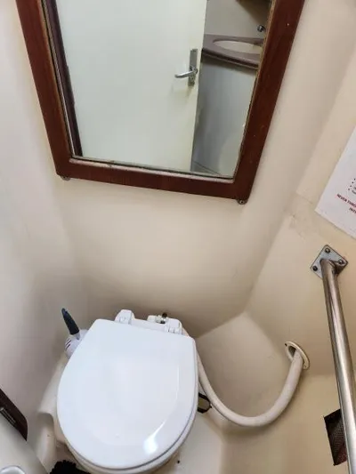 Plan B Yacht Photos Pics 1998 Hunter 450 Passage yacht bathroom with toilet, mirror, and handrail.
