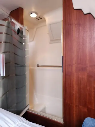 Plan B Yacht Photos Pics Shower area in 1998 Hunter 450 Passage yacht with wooden paneling and frosted glass door.