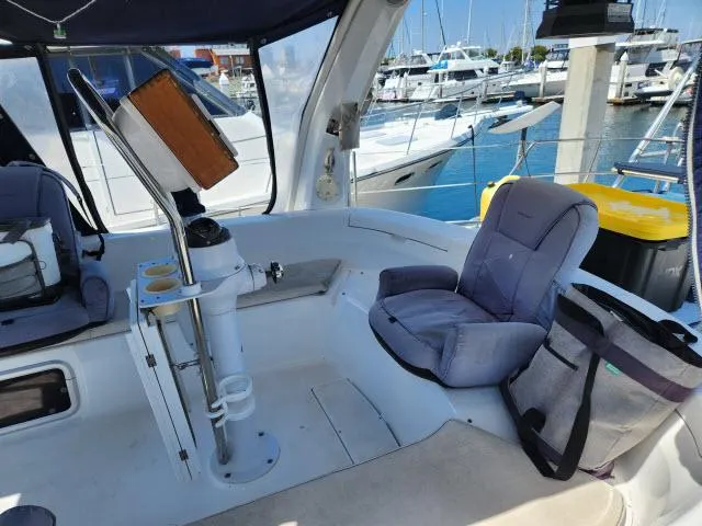 Plan B Yacht Photos Pics Cockpit of a 1998 Hunter 450 Passage yacht with cushioned seating and marina view.