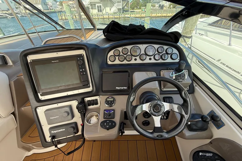  Yacht Photos Pics 2008 Cruisers Yachts 420 Express helm with navigation controls and steering wheel.