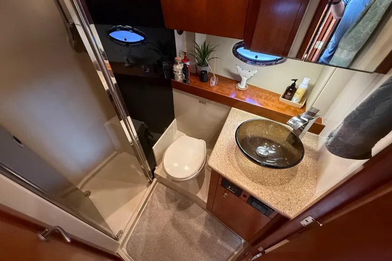  Yacht Photos Pics Luxurious bathroom in 2008 Cruisers Yachts 420 Express with glass sink and shower.