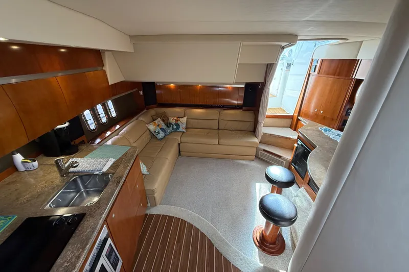  Yacht Photos Pics Luxurious interior of 2008 Cruisers Yachts 420 Express with modern kitchen and cozy seating area.