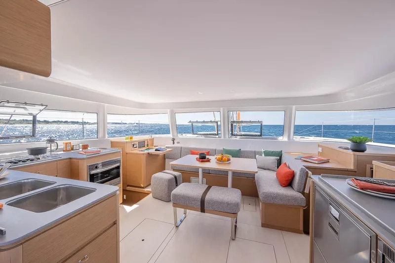  Yacht Photos Pics Manufacturer Provided Image: Luxurious interior of 2026 Excess 14 catamaran with modern kitchen and ocean view.