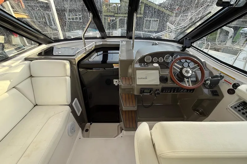 Valubelle Yacht Photos Pics Interior of 2012 Regal 35 Sport Coupe boat with steering wheel and Garmin navigation system.