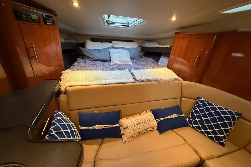 Valubelle Yacht Photos Pics Interior of 2012 Regal 35 Sport Coupe with cozy seating and decorative pillows.