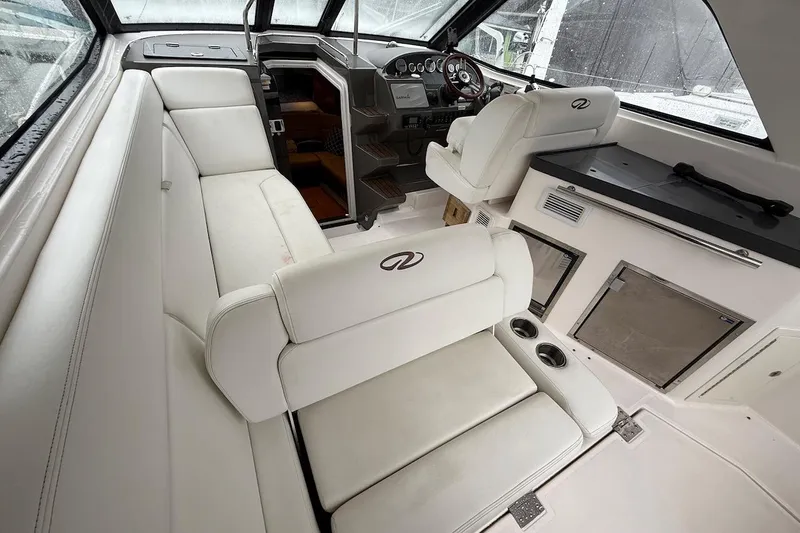 Valubelle Yacht Photos Pics Interior of 2012 Regal 35 Sport Coupe with white seating and modern dashboard.