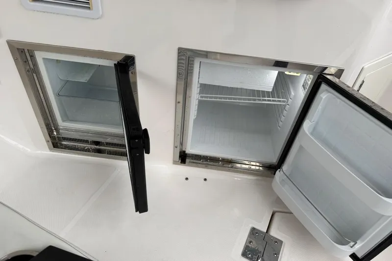 Valubelle Yacht Photos Pics 2012 Regal 35 Sport Coupe boat interior with open mini fridge compartments.