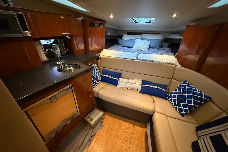 Valubelle Yacht Photos Pics Luxurious interior of 2012 Regal 35 Sport Coupe with cozy seating and modern kitchenette.