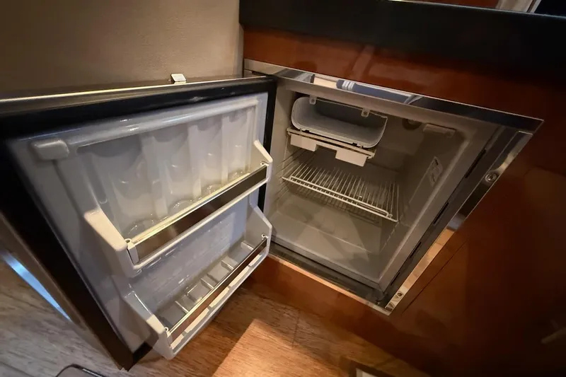 Valubelle Yacht Photos Pics Open refrigerator inside 2012 Regal 35 Sport Coupe, showcasing interior storage and shelving.