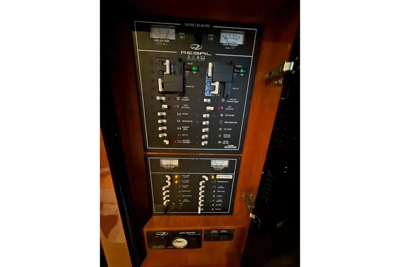 Valubelle Yacht Photos Pics Control panel of a 2012 Regal 35 Sport Coupe boat, featuring various switches and indicators.